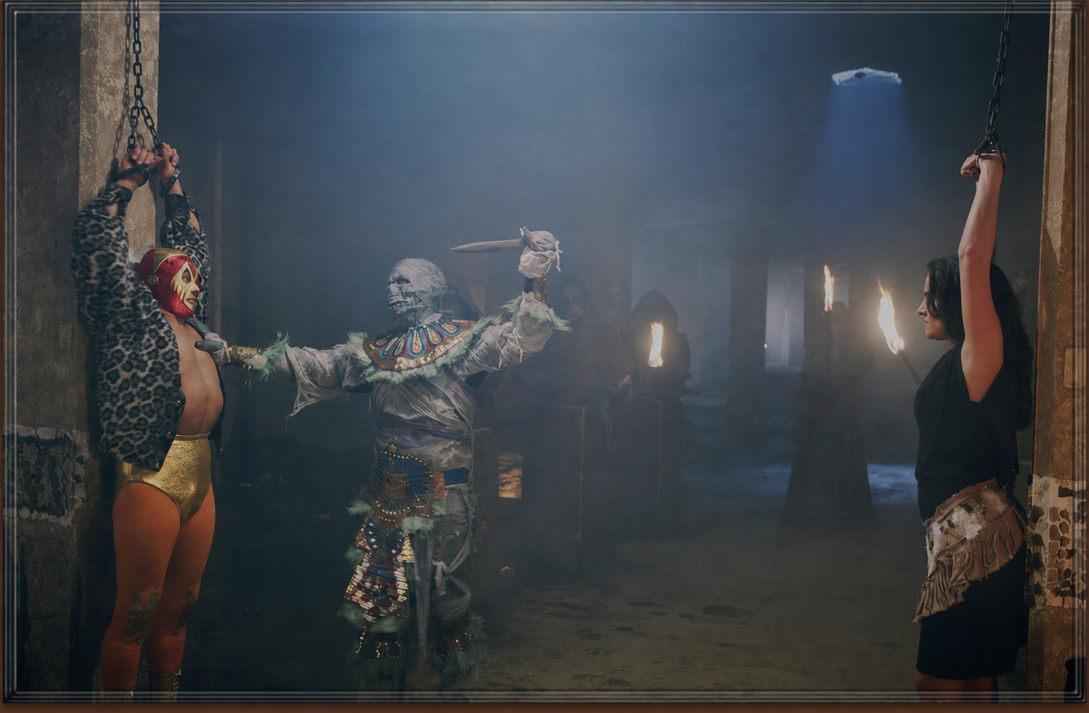 Mil Mascaras confronting the Aztec Mummy in a torchlit chamber